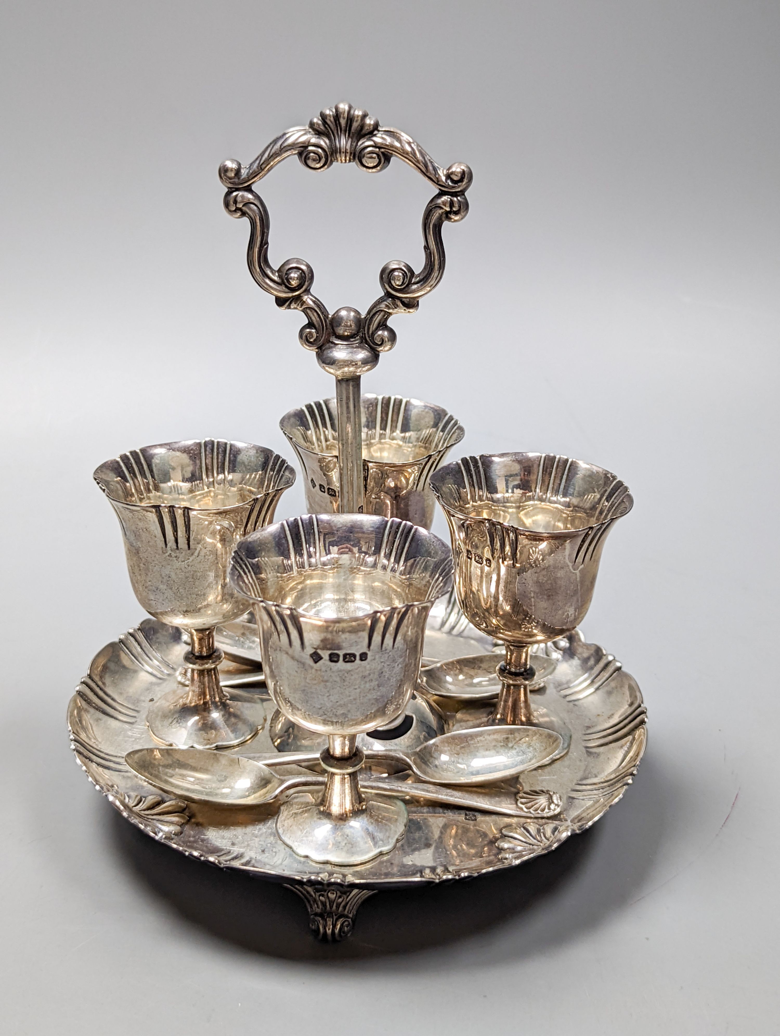 A late Victorian silver egg cruet, with four cups and four associated spoons, Martin, Hall & Co, Sheffield, 1895, height 18.2cm, 18oz.